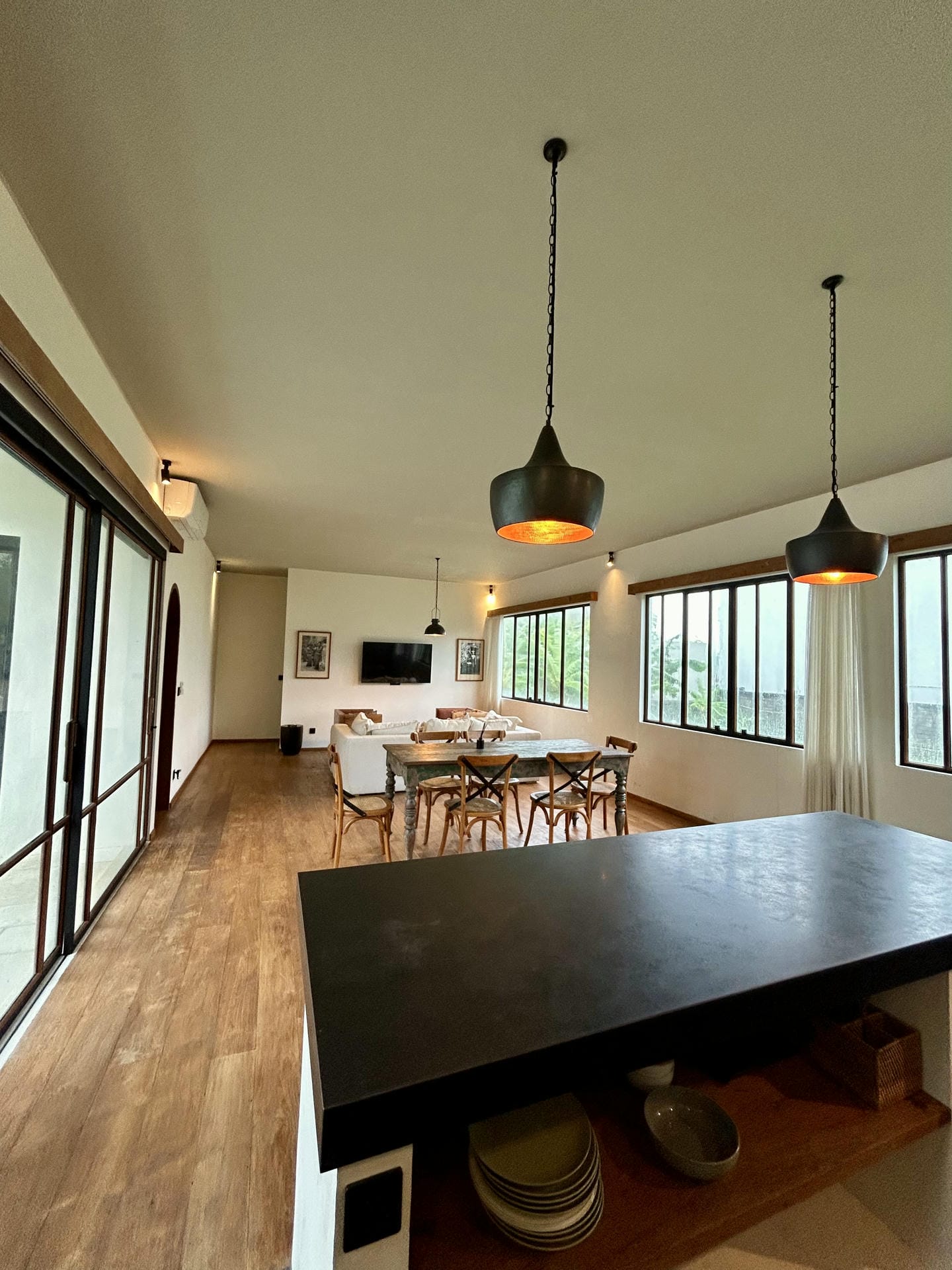 Modern dining area with wooden flooring and lighting.