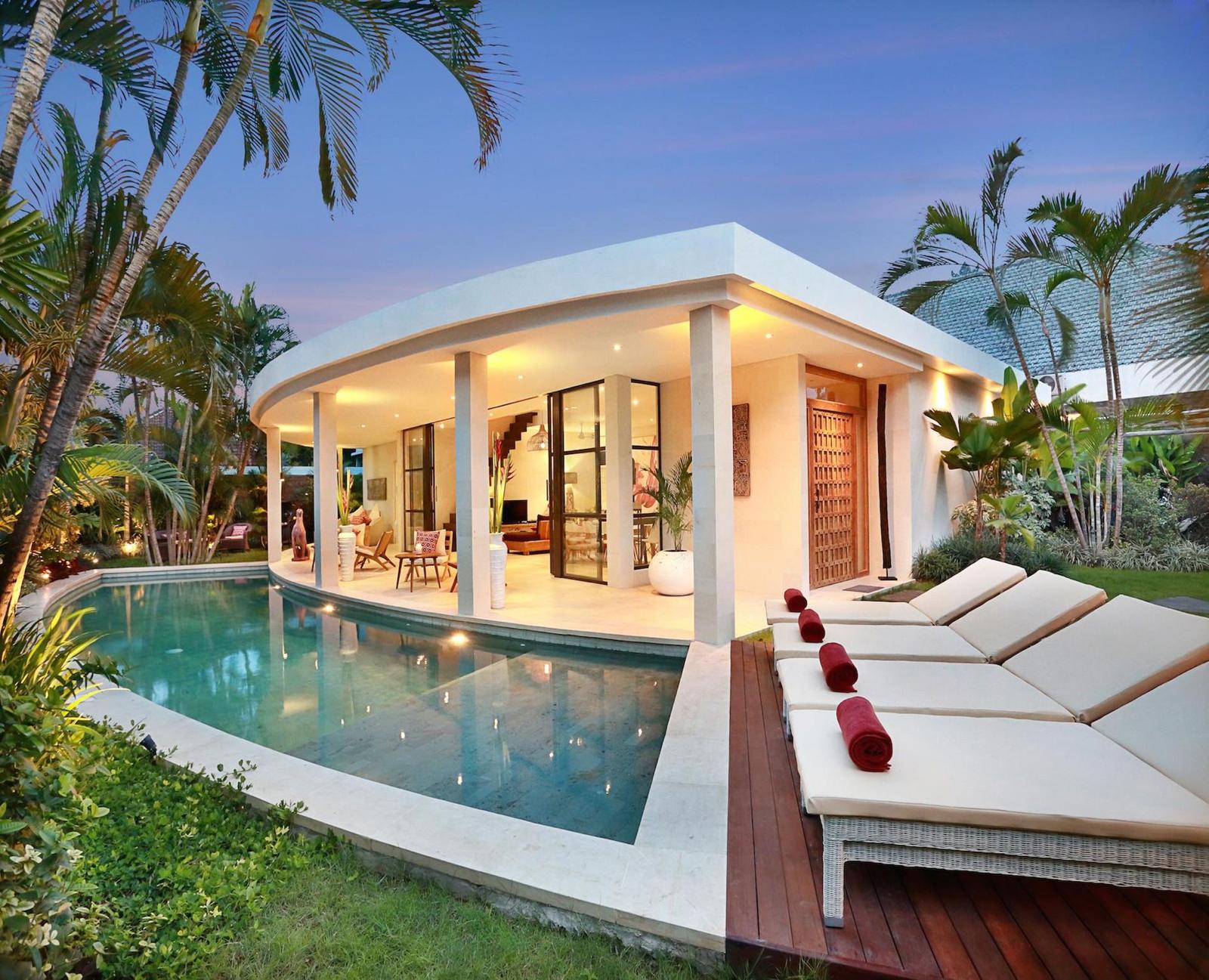 Luxury villa with pool at sunset.