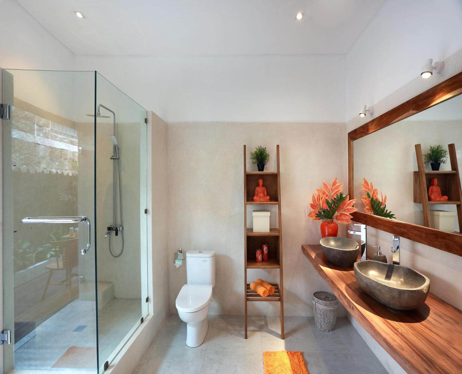 Modern bathroom with stone sink and glass shower.