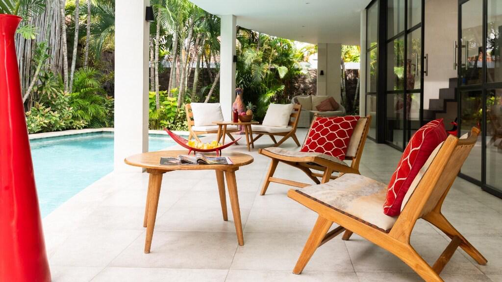 Outdoor patio with chairs and poolside view.