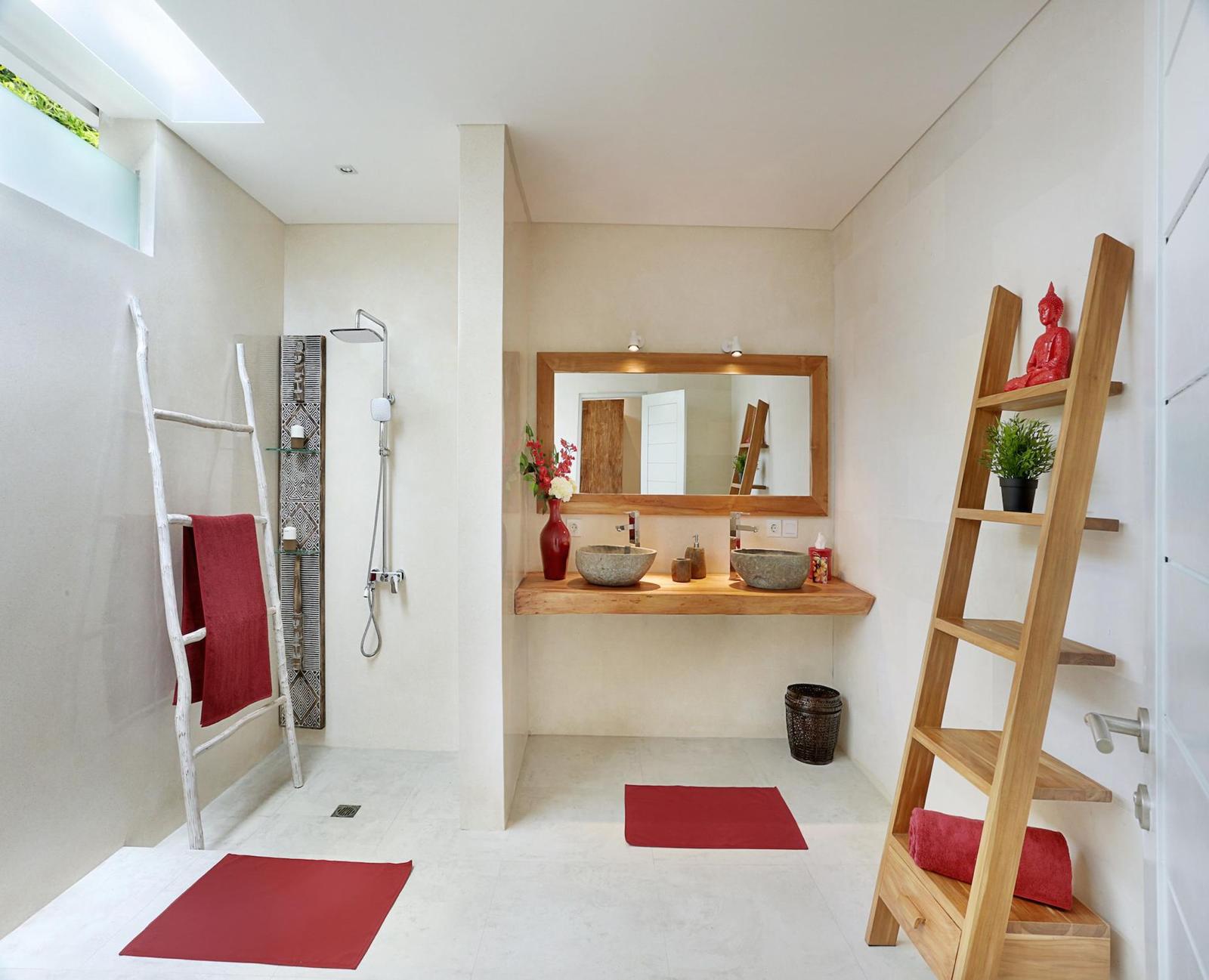 Modern bathroom with red accents and wooden decor.