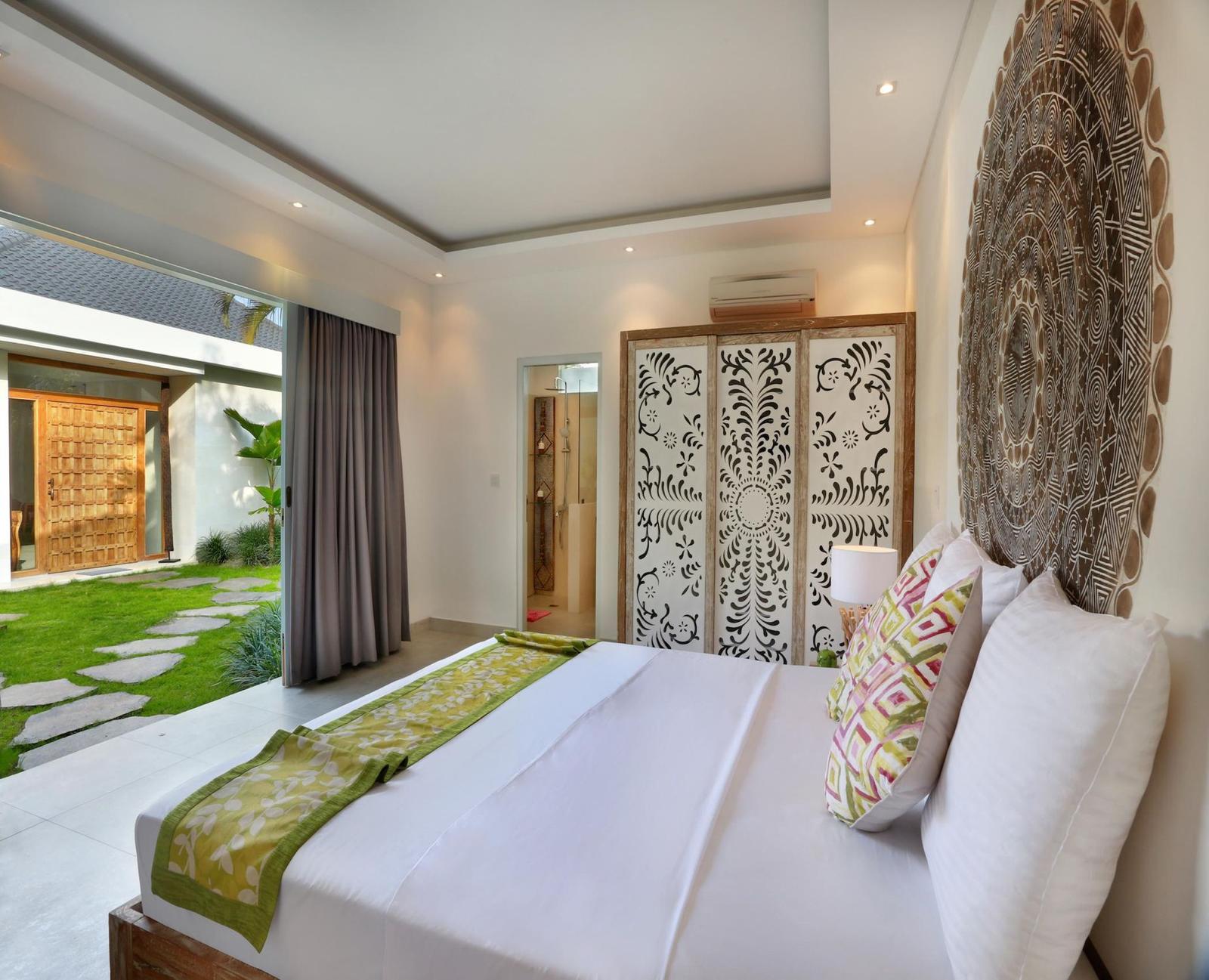 Elegant bedroom with garden view and decorative wall art.