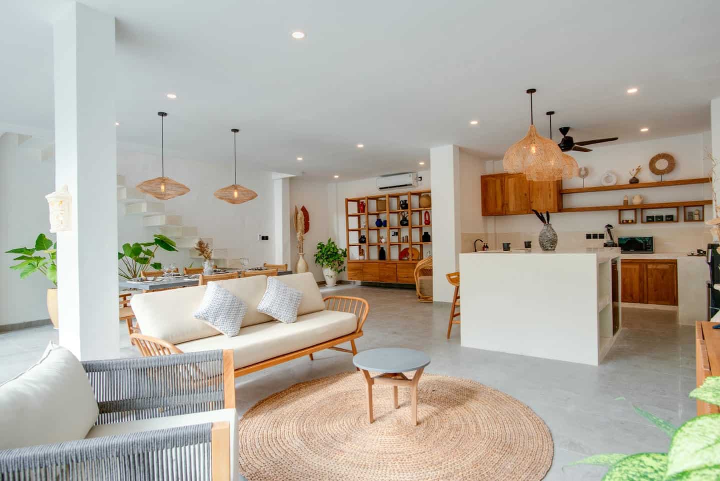 Modern open-plan living room with kitchen and decor.