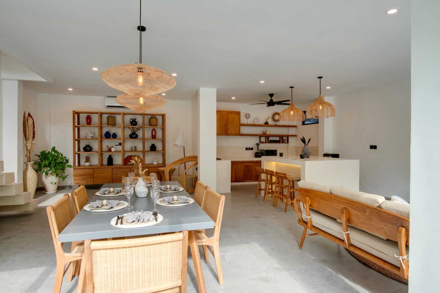 Modern dining and kitchen area with wooden furniture.