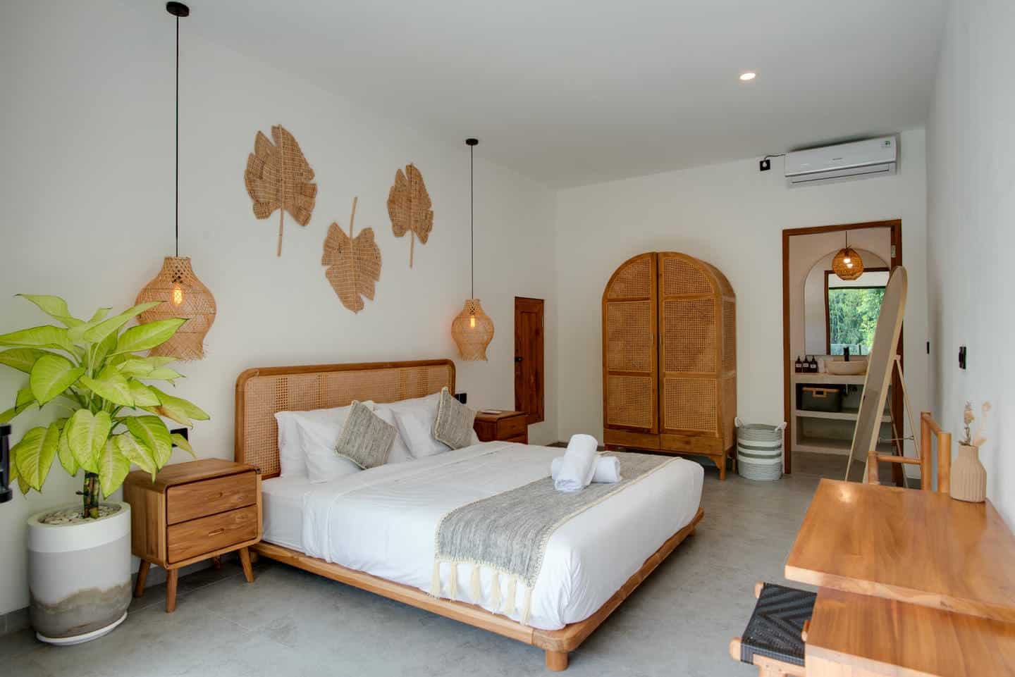 Modern bedroom with wooden decor and plants.