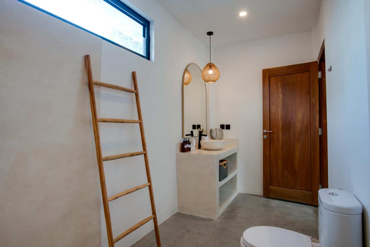 Minimalist bathroom with wooden ladder decor