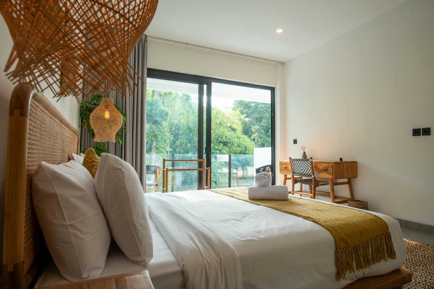 Modern bedroom with large window and cozy decor.