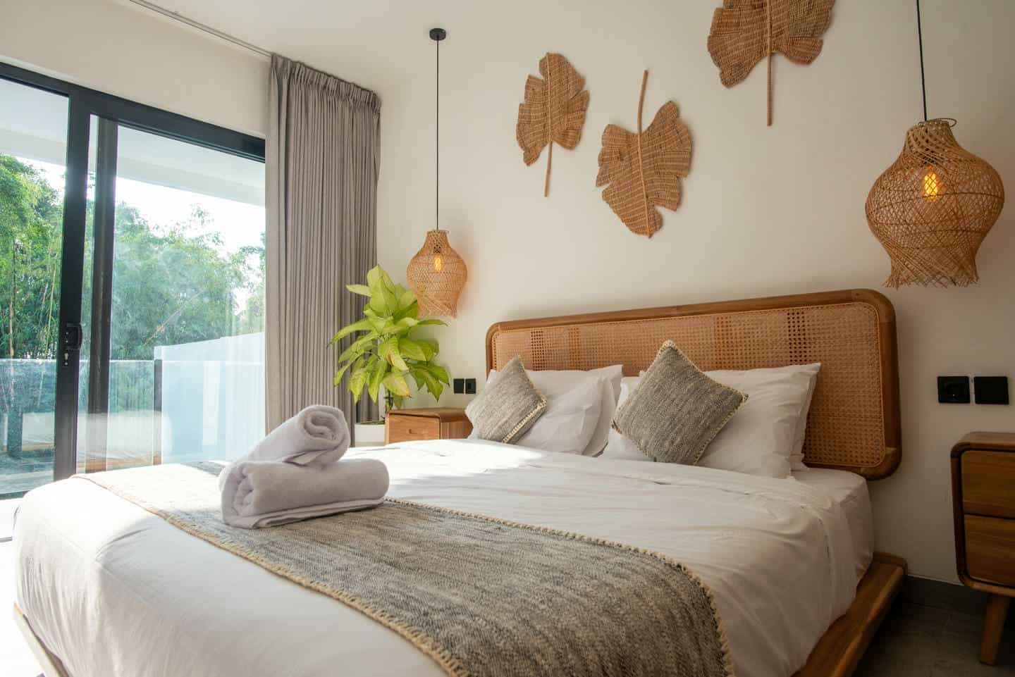 Modern bedroom with woven decor and natural light.
