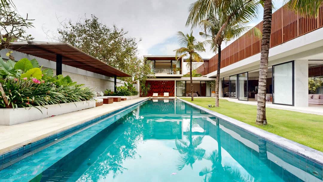 Luxury villa with modern pool and garden view.