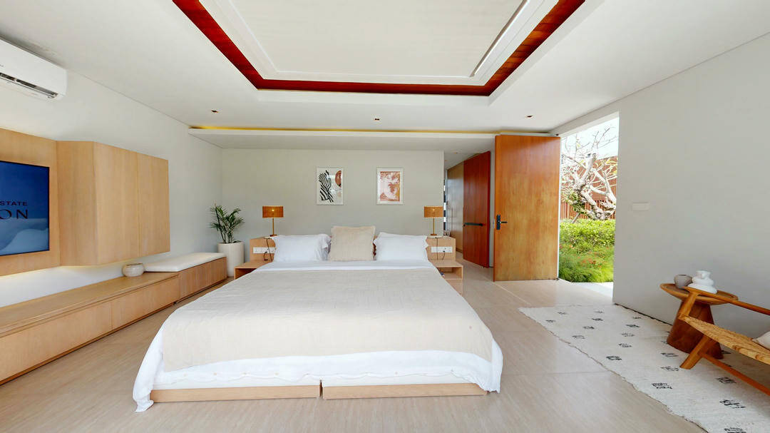 Modern bedroom with large bed and open door