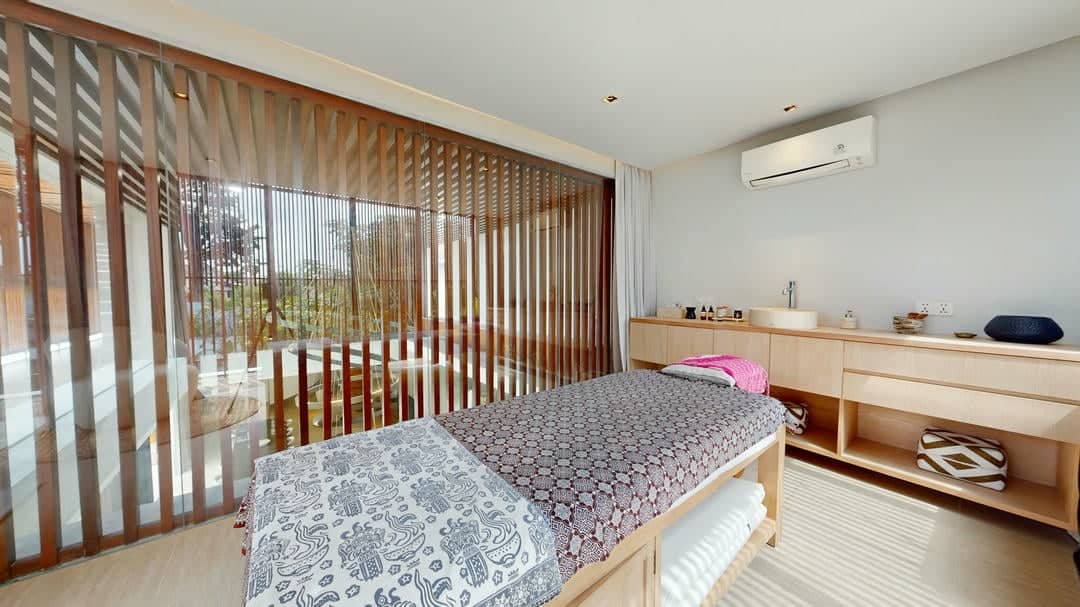 Modern spa treatment room with massage table.