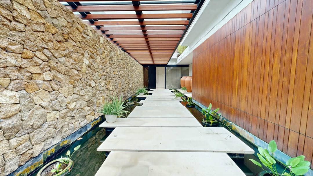 Modern walkway with stone wall and plants