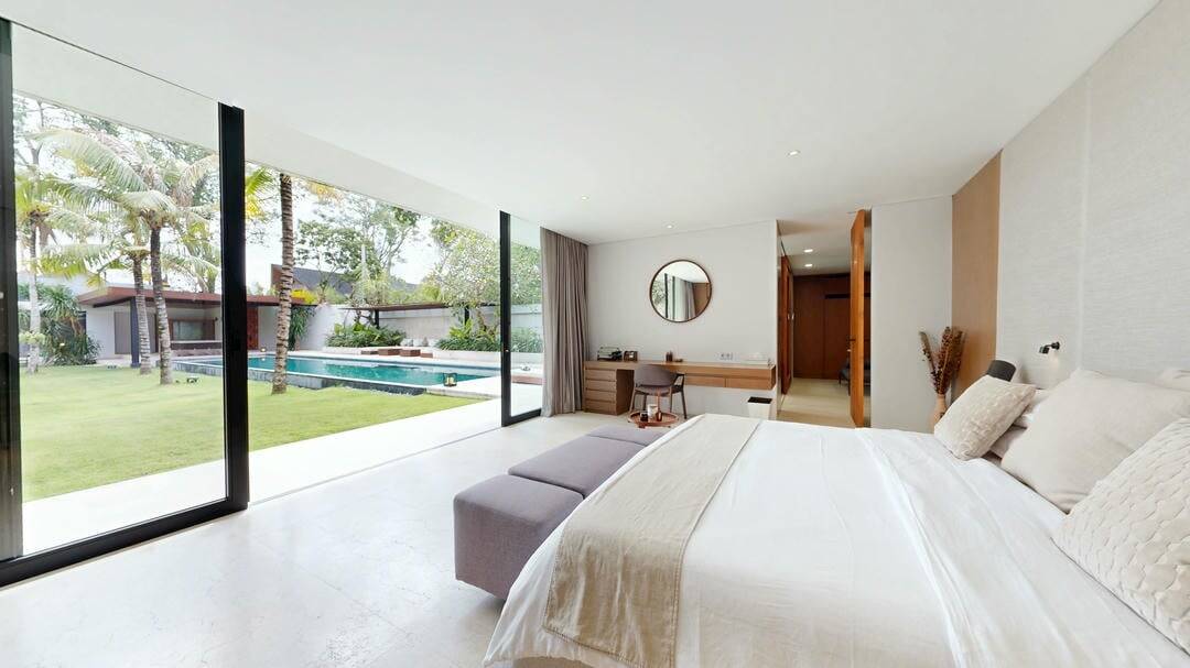 Modern bedroom with glass doors and pool view.