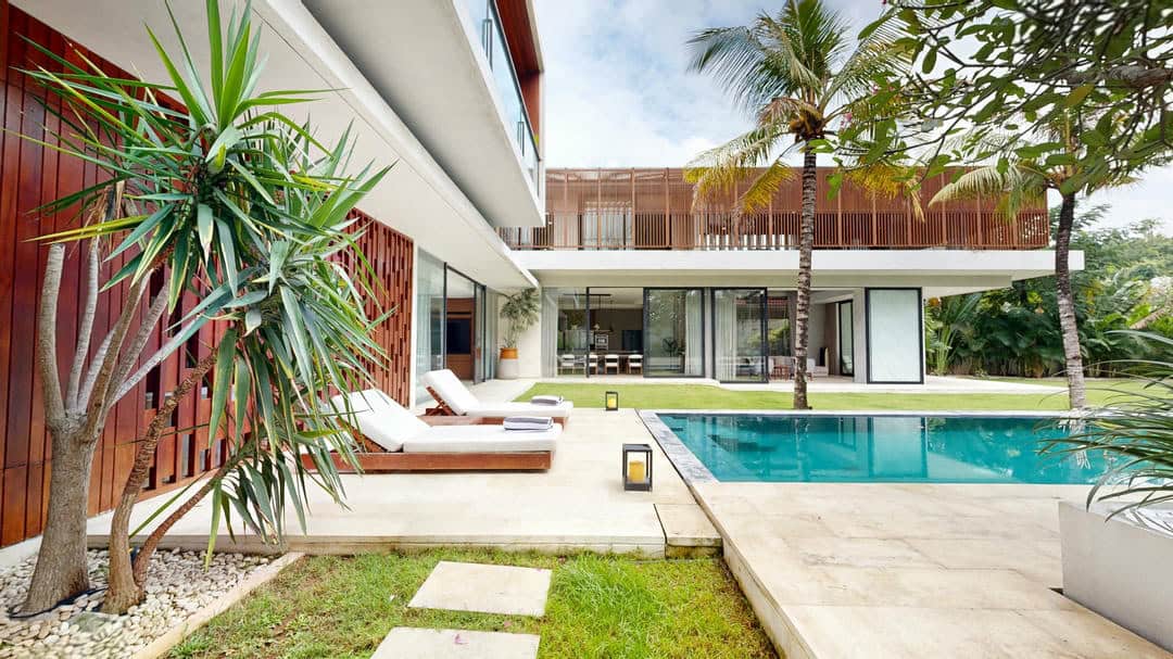 Luxury modern villa with pool and palm trees.