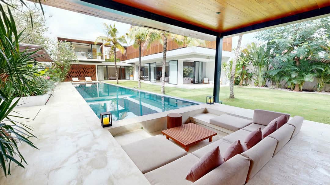Modern villa with pool and outdoor seating area.
