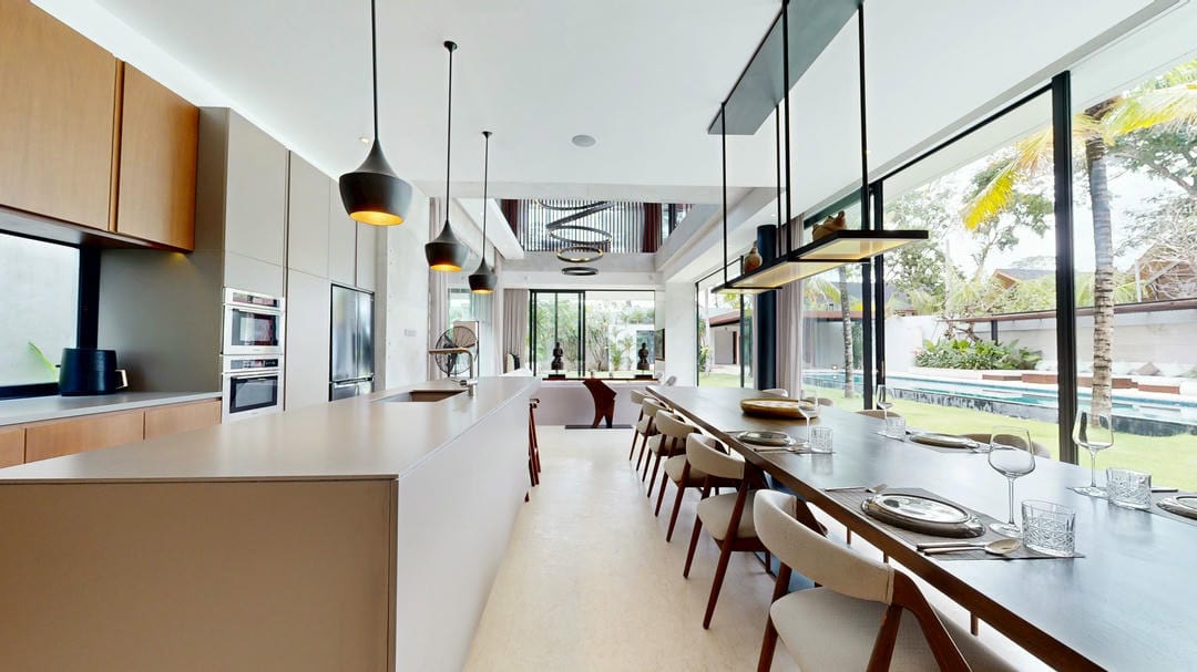 Modern kitchen and dining area with outdoor view.