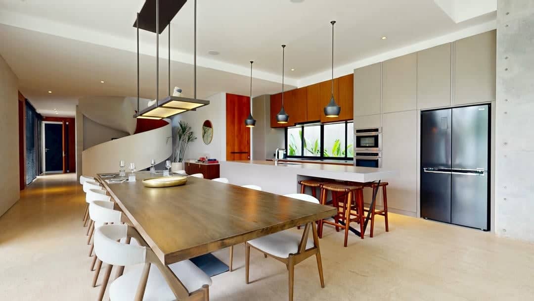 Modern kitchen and dining area with wooden decor.