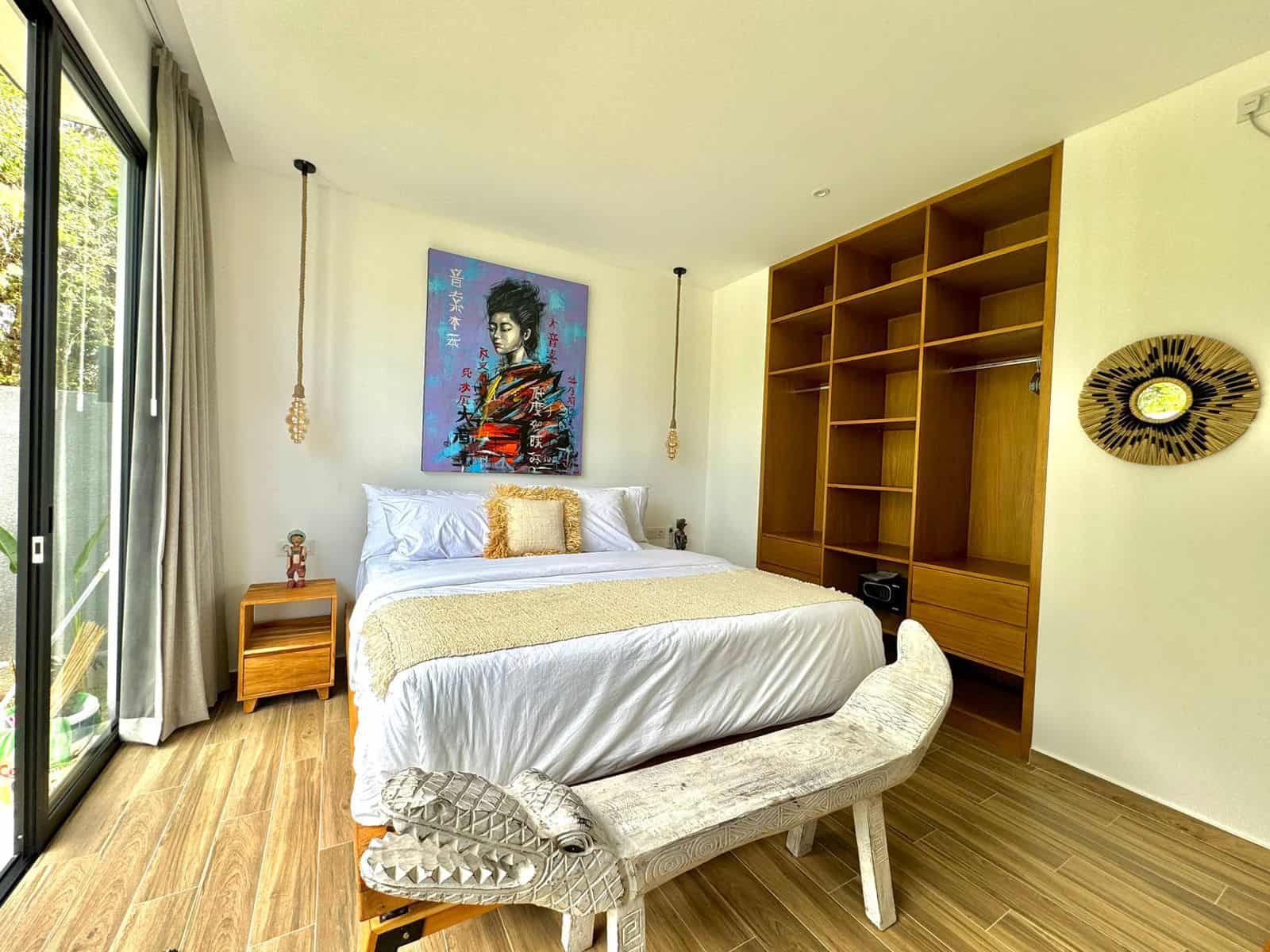 Modern bedroom with artwork and wooden furniture