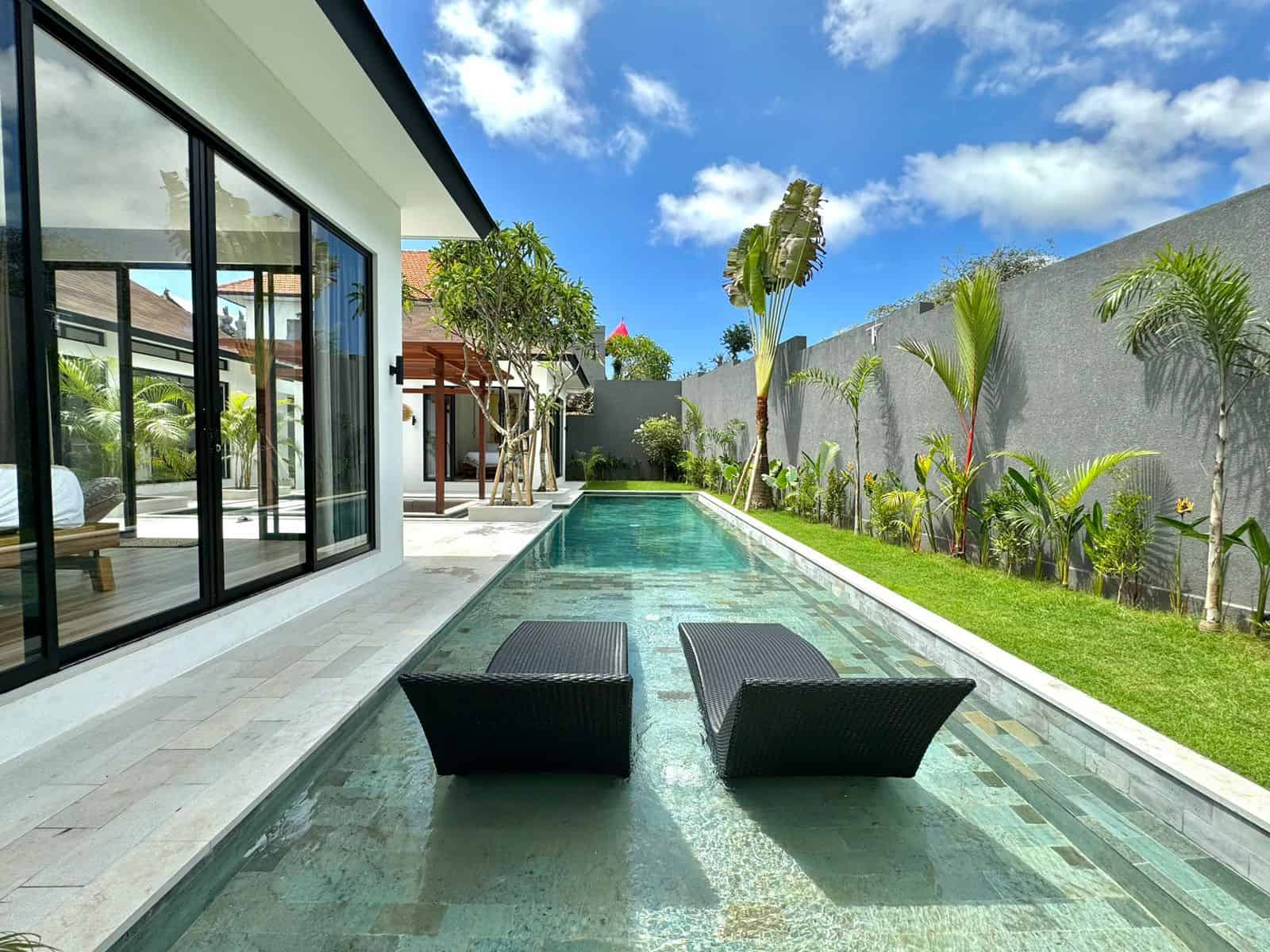 Modern villa with pool and lounge chairs