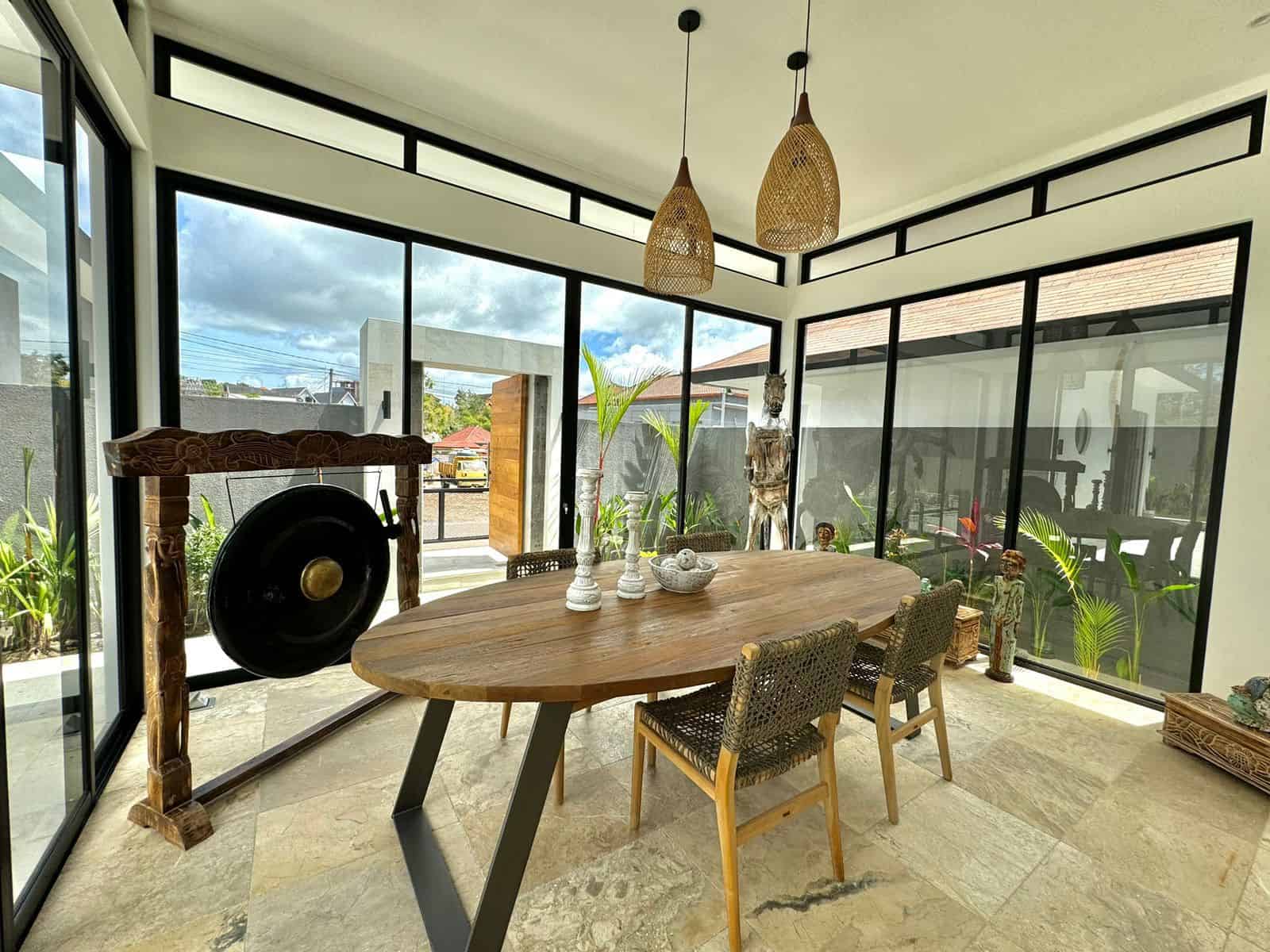 Bright dining room with gong and wooden decor.