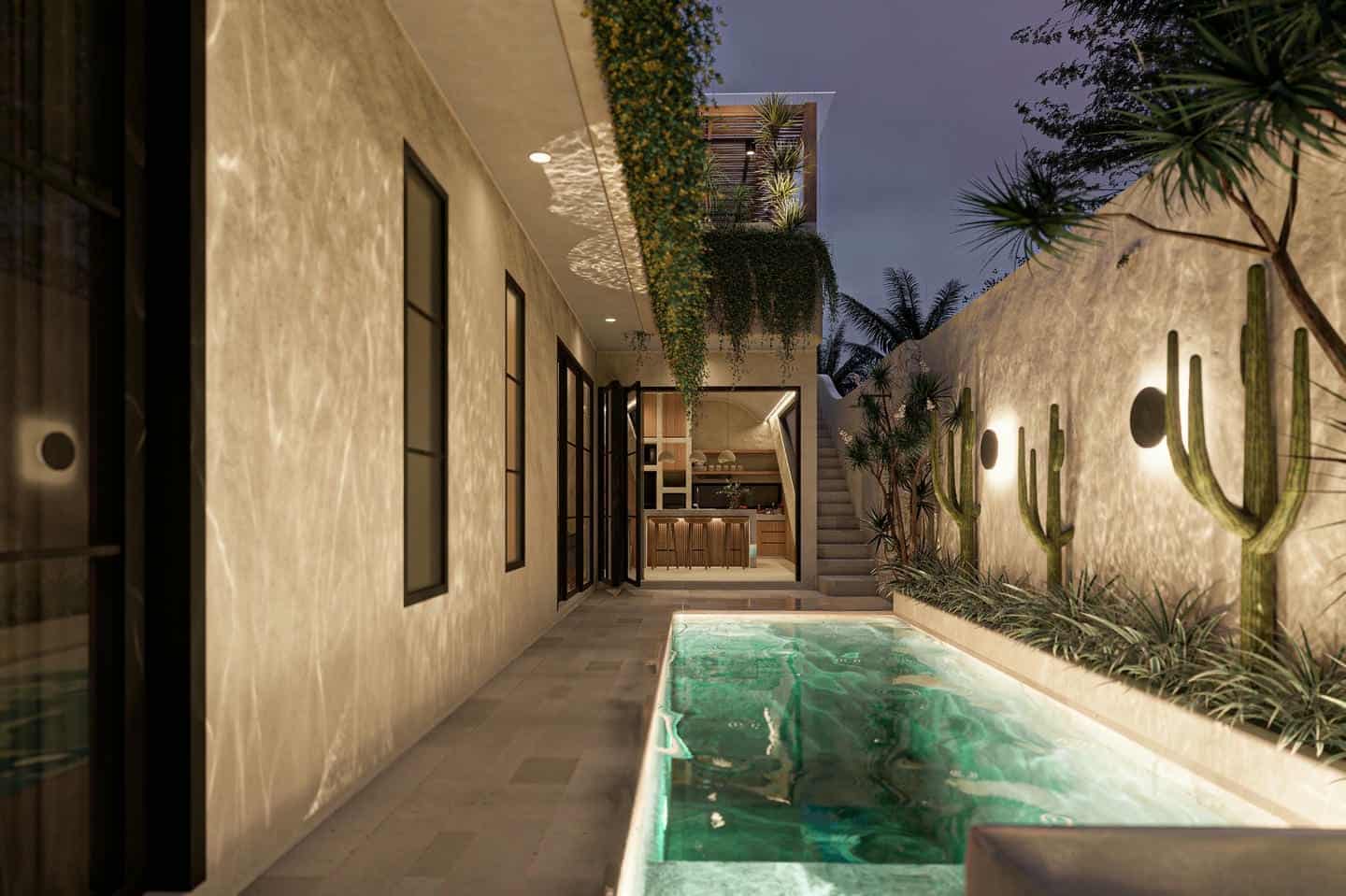 Modern patio with illuminated pool and tropical plants.