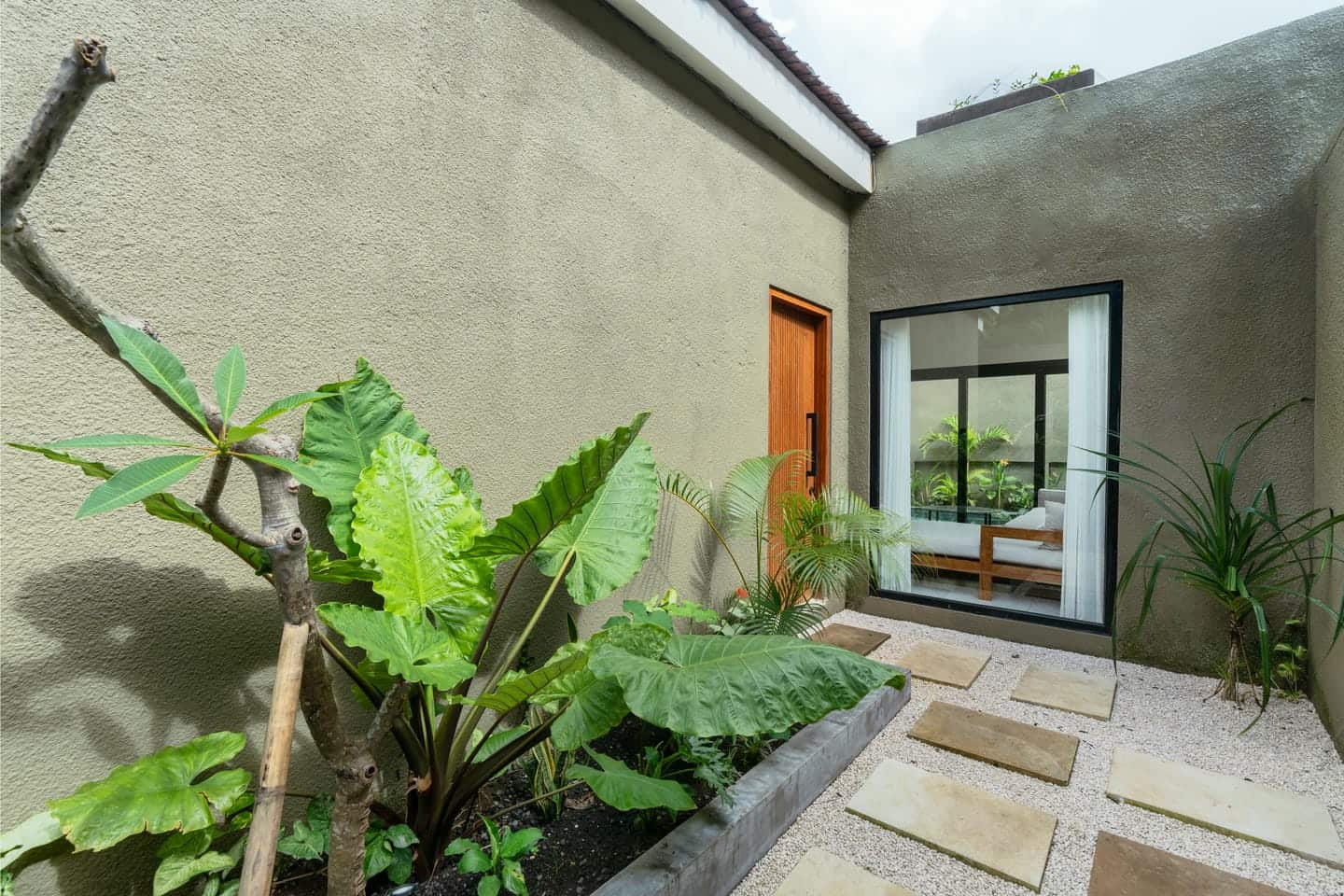Modern courtyard with plants and stepping stones.
