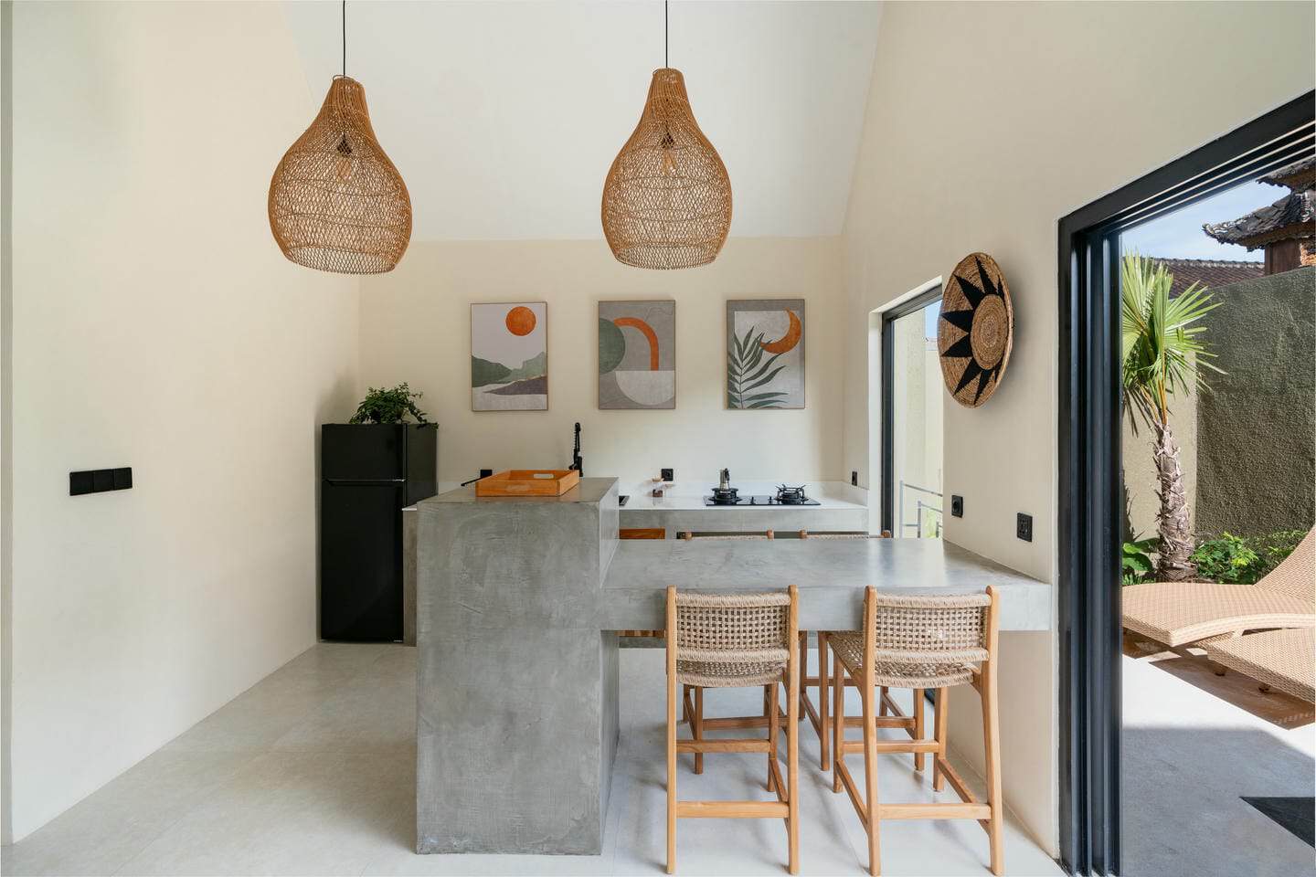 Modern kitchen with wicker accents and outdoor view.