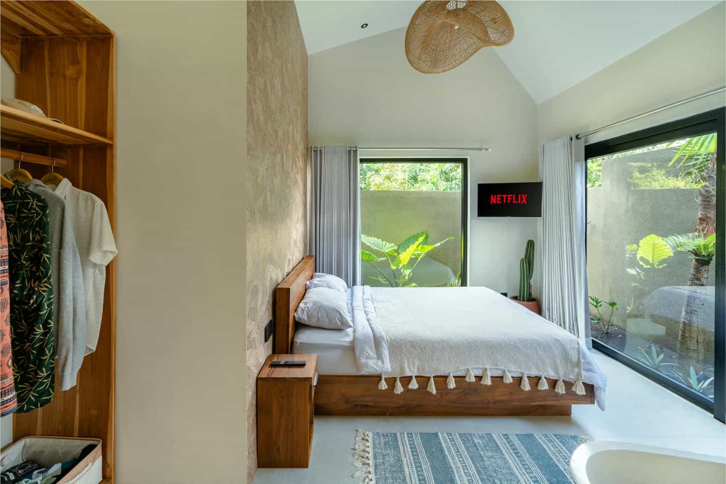 Cozy bedroom with tropical garden view.