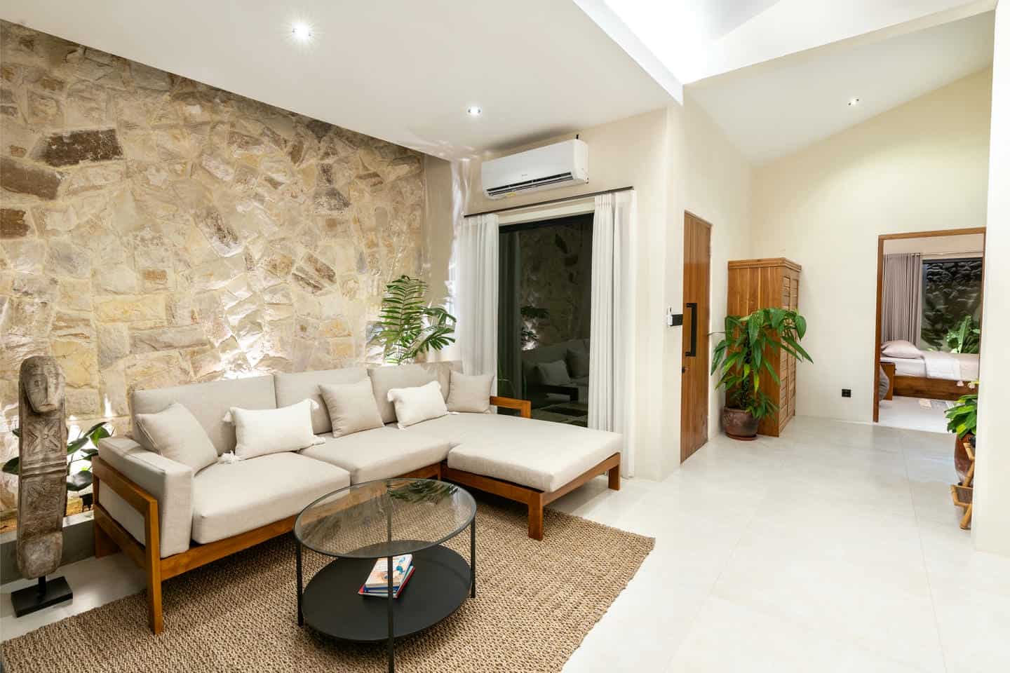 Modern living room with stone wall and cozy furniture.