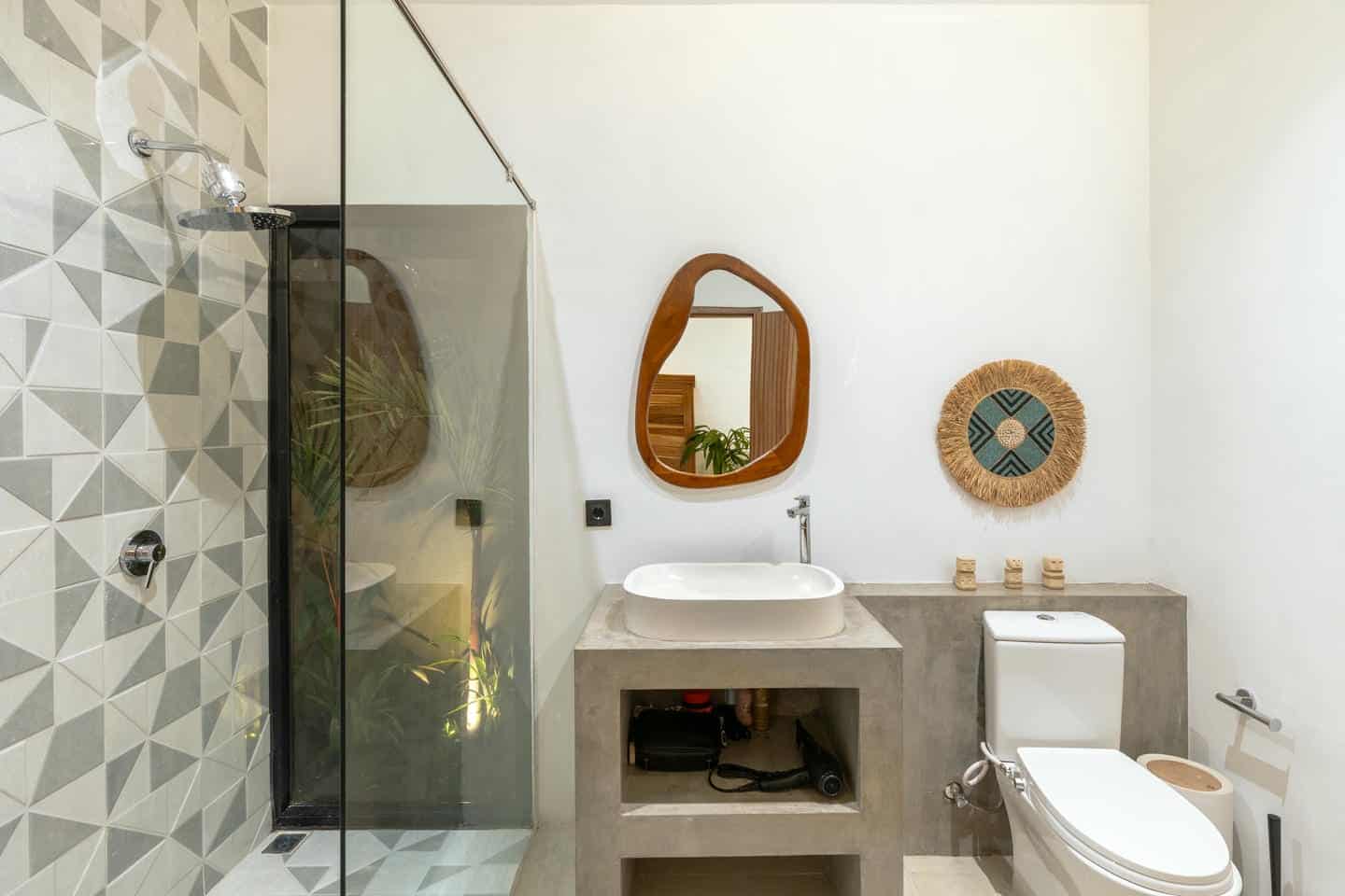 Modern bathroom with geometric tiles and minimalist decor.