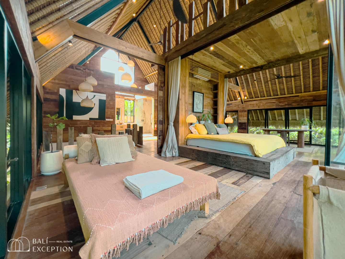 Rustic luxury bedroom with wooden decor and natural light.