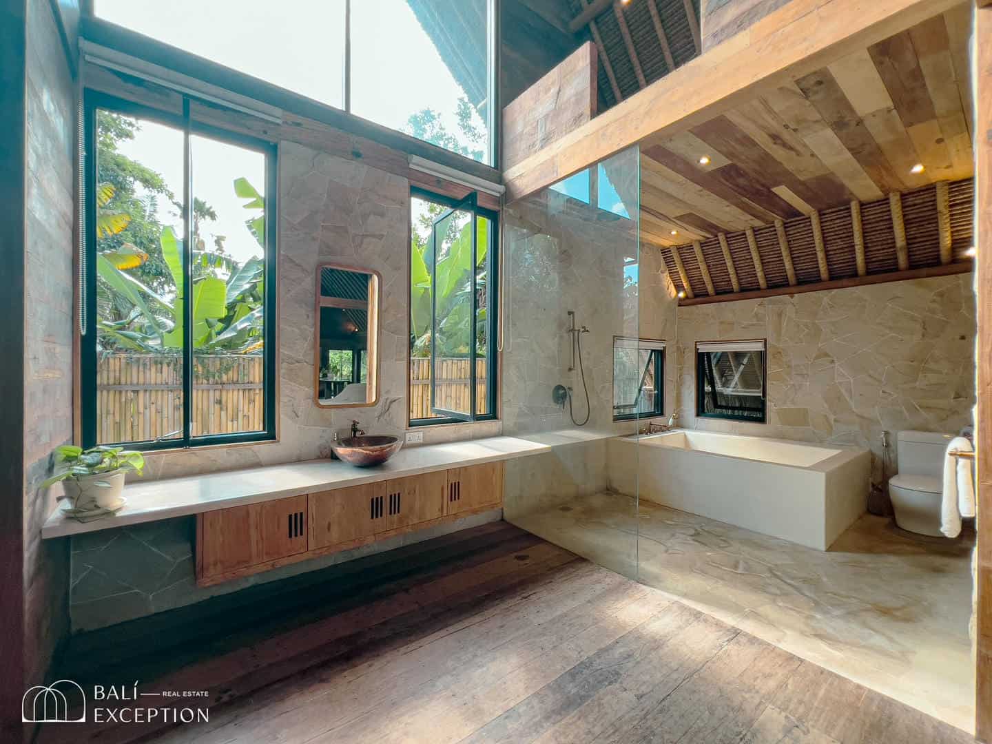 Spacious modern bathroom with large windows and tub.
