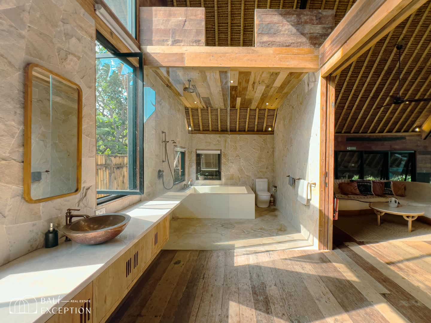Luxurious open-air bathroom with tropical decor.
