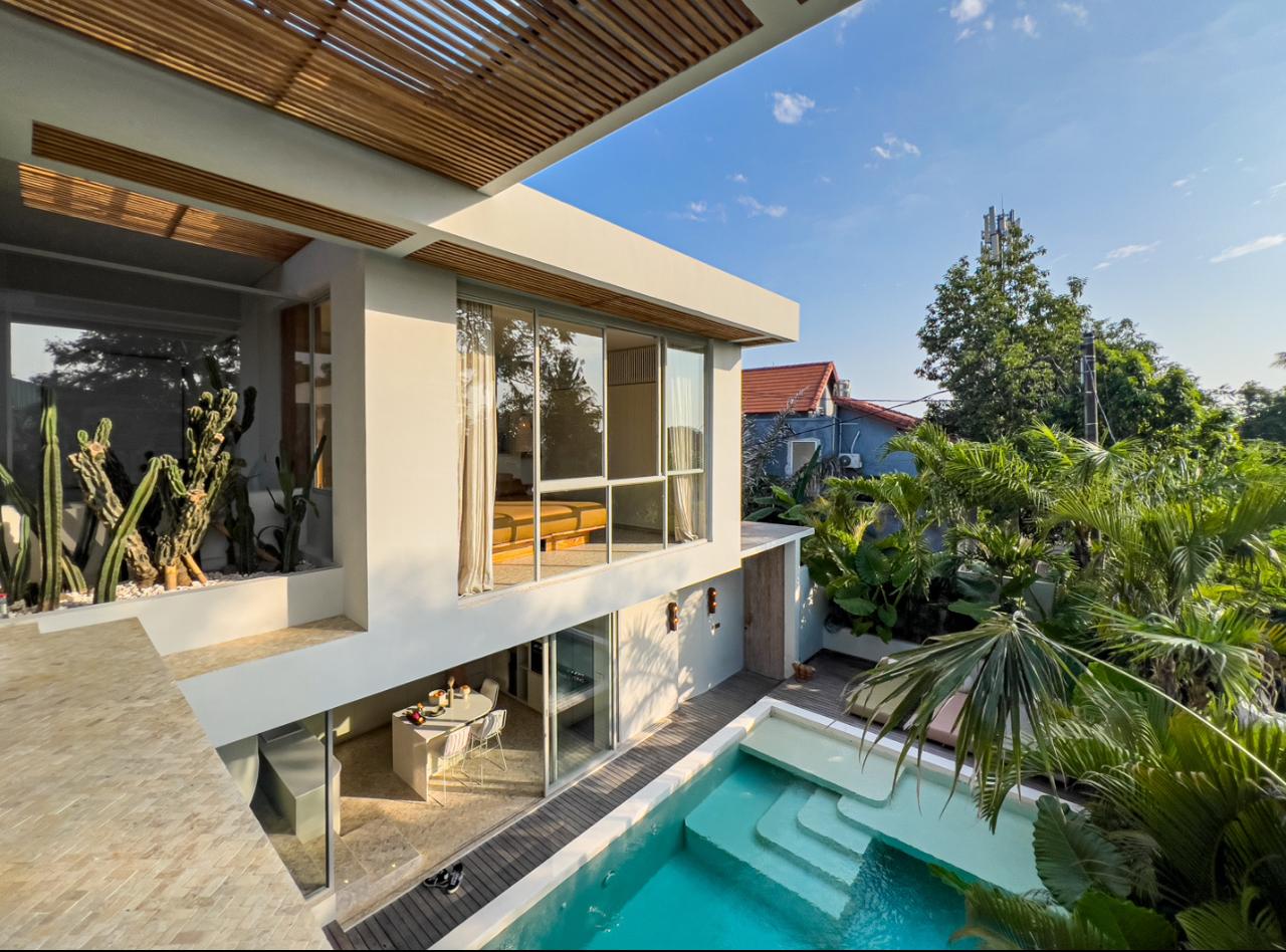 Modern house with pool and lush garden.