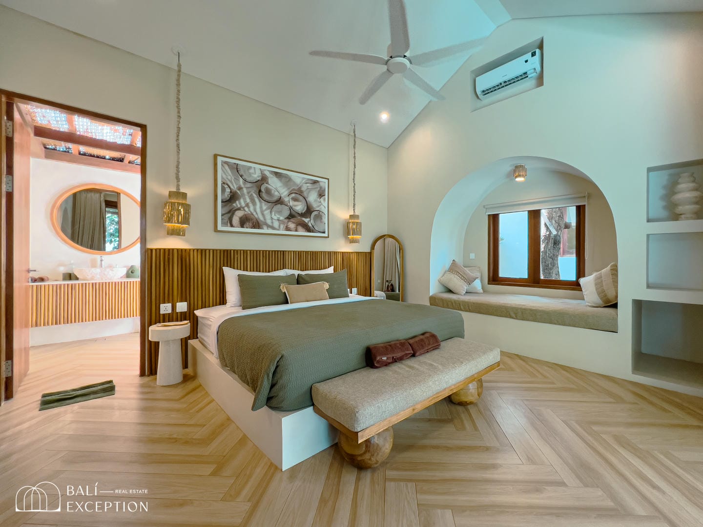 Modern bedroom with wooden accents and cozy seating area.