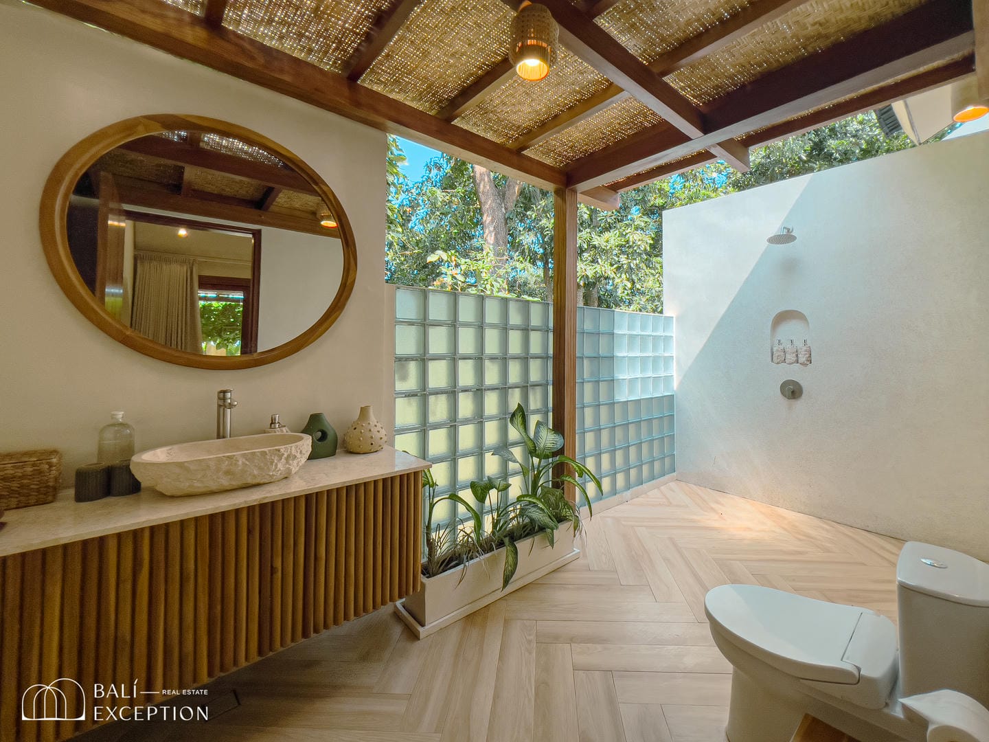 Luxurious outdoor bathroom with shower and garden view.