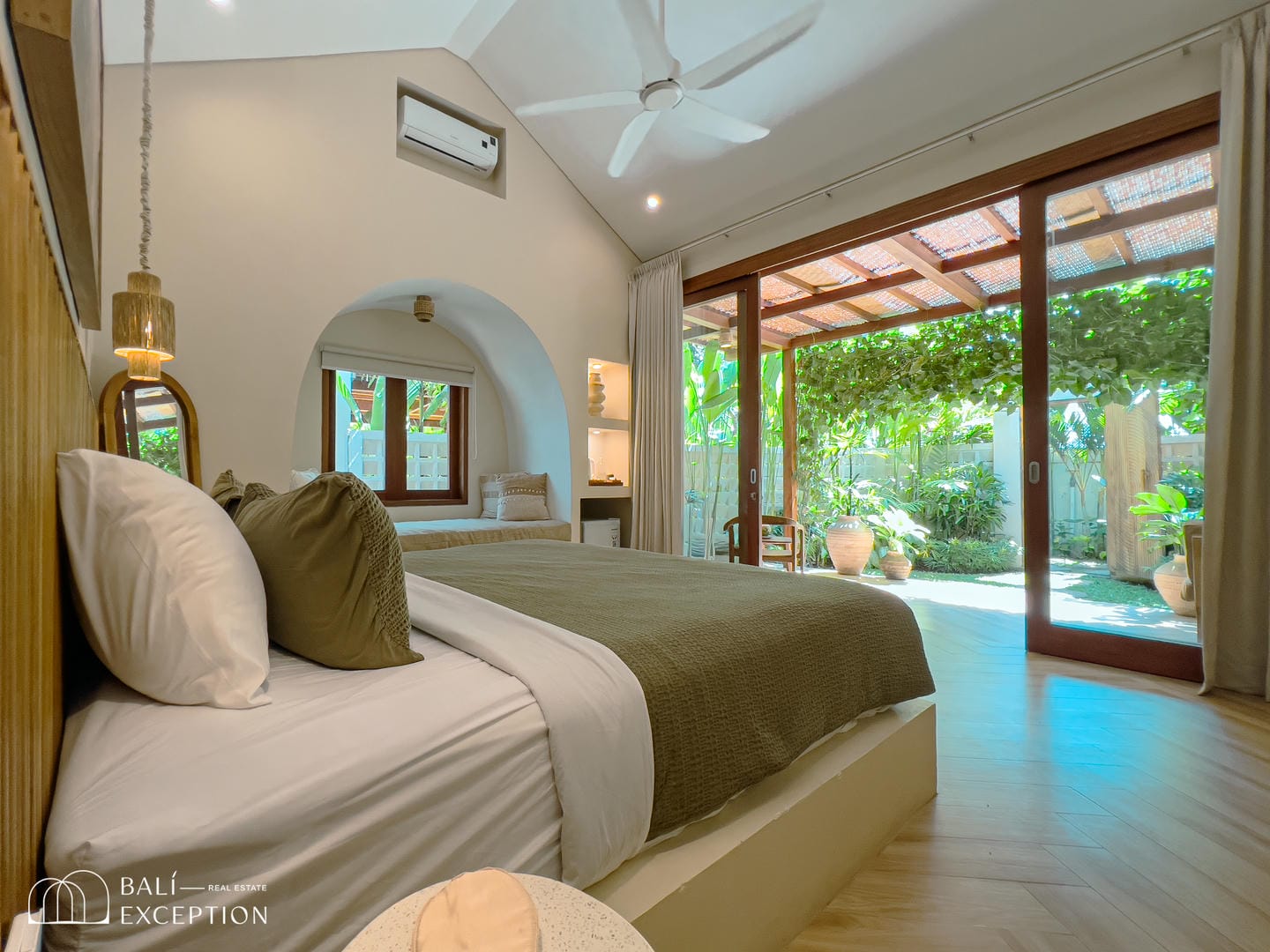 Modern bedroom with garden view and natural light.