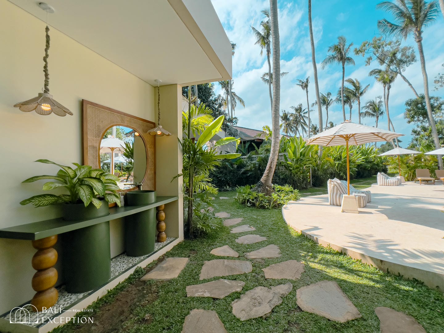 Tropical patio with lounge chairs and palm trees