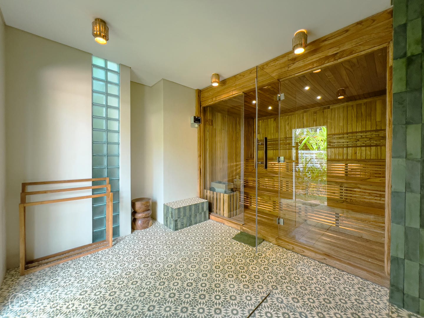 Modern indoor sauna with glass door and wood interior.