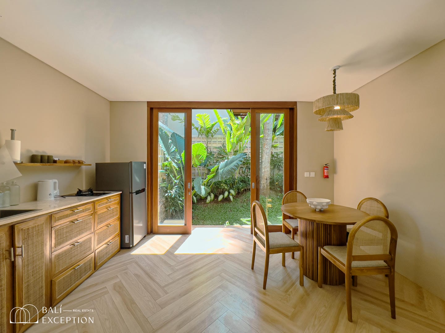 Modern kitchen with garden view, wooden furniture.