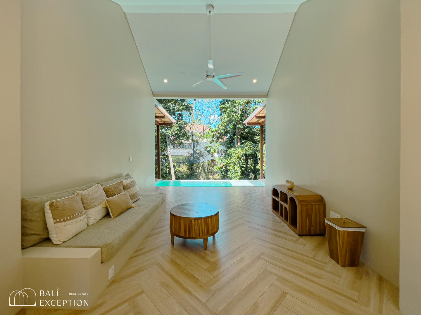 Modern living room with garden view and pool.