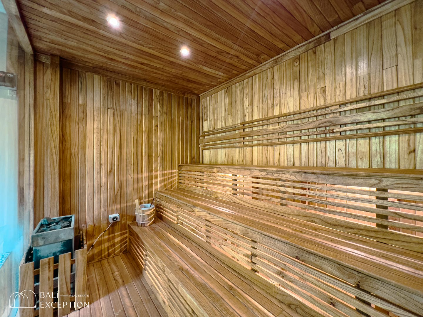 Wooden sauna interior with benches and heater