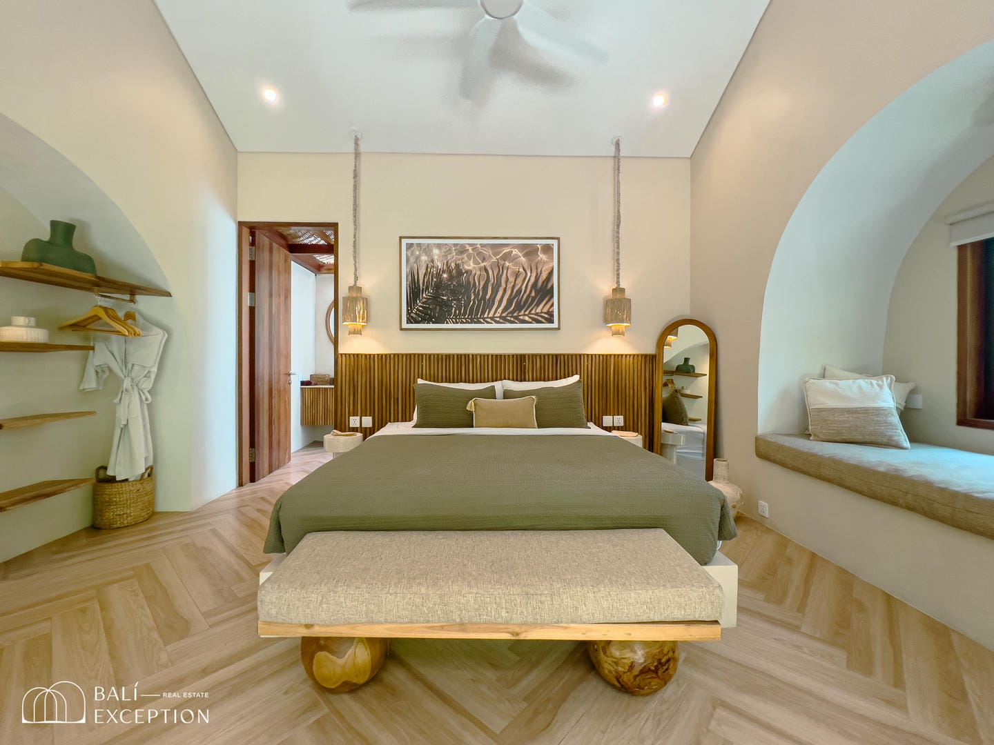 Elegant bedroom with wooden floors and neutral decor.